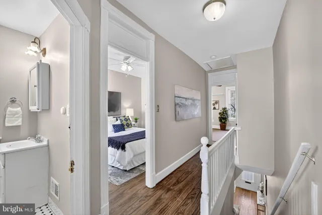 a view of a hallway with furniture and wooden floor