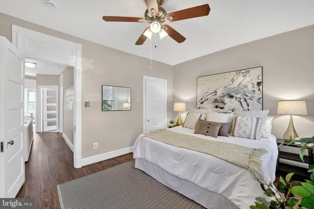 a bedroom with a large bed and a chandelier