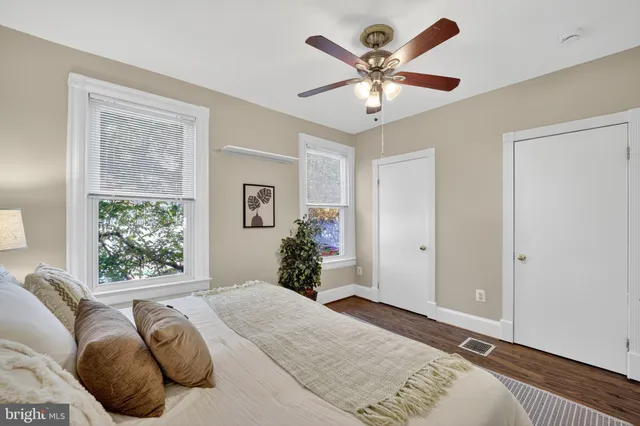 a bed room with a bed and a large window