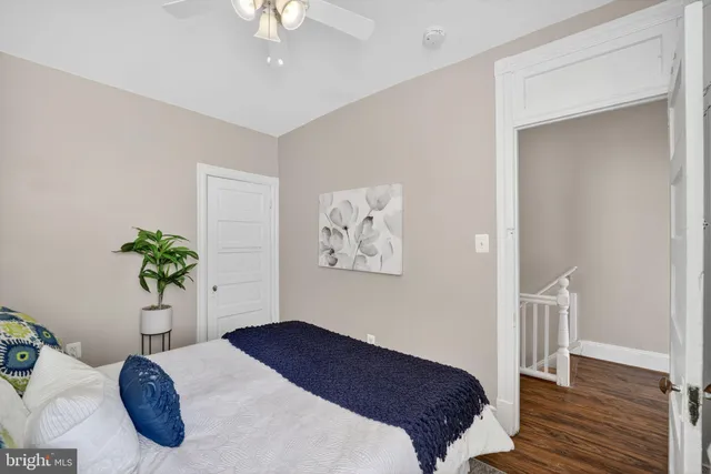 a bedroom with a bed and a potted plant