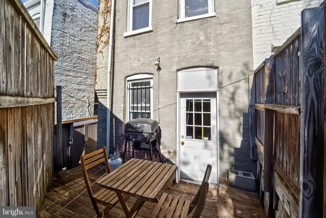 a view of balcony with chairs and wooden fence