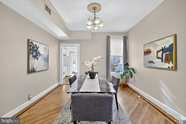 a living room with furniture chandelier and a window