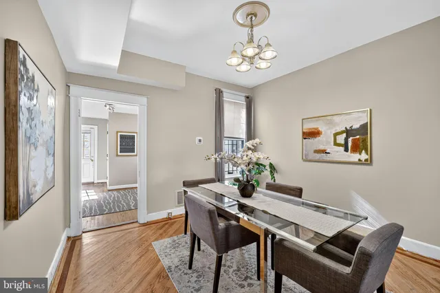 a view of a dining room with furniture and chandelier