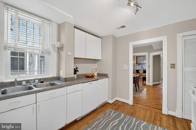 a kitchen with sink and cabinets