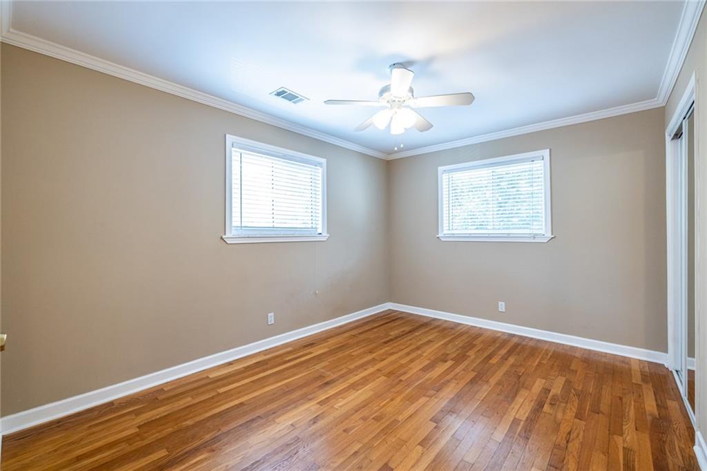 263 Jefferson Place, Unit 31 Decatur, GA 30030 - Photo 12 of 27 a view of an empty room with wooden floor and a window