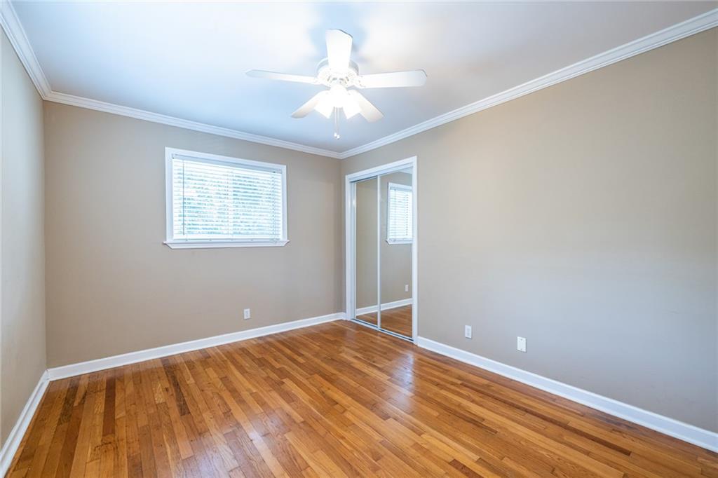 263 Jefferson Place, Unit 31 Decatur, GA 30030 - Photo 15 of 27 an empty room with wooden floor and windows