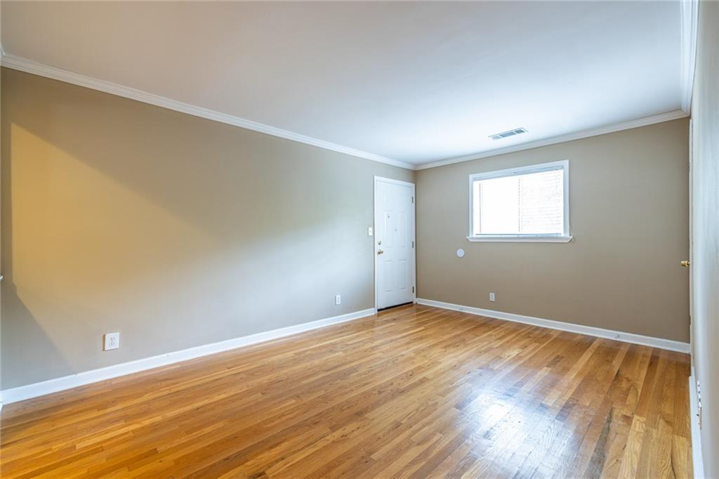 263 Jefferson Place, Unit 31 Decatur, GA 30030 - Photo 2 of 27 an empty room with wooden floor and windows