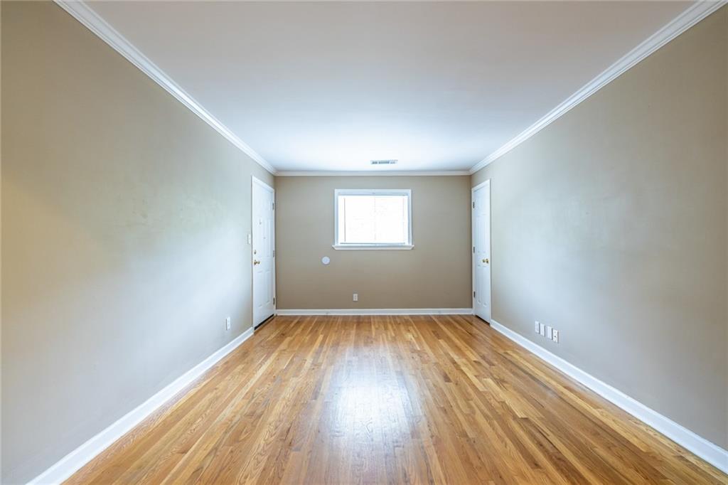 263 Jefferson Place, Unit 31 Decatur, GA 30030 - Photo 4 of 27 an empty room with wooden floor and windows