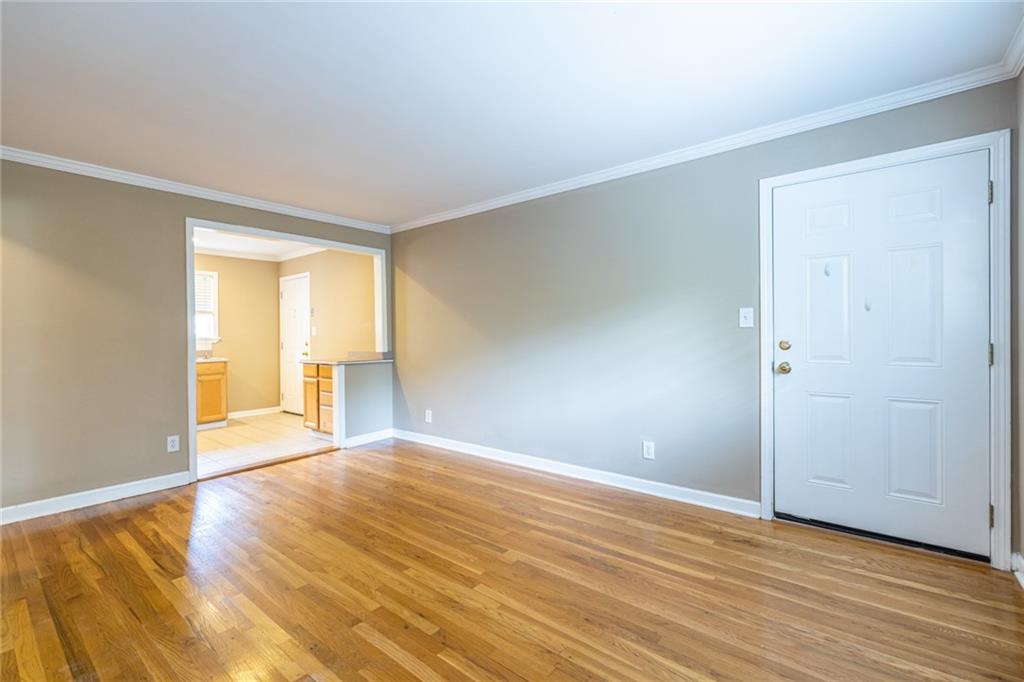 263 Jefferson Place, Unit 31 Decatur, GA 30030 - Photo 6 of 27 a view of an empty room with wooden floor and a window