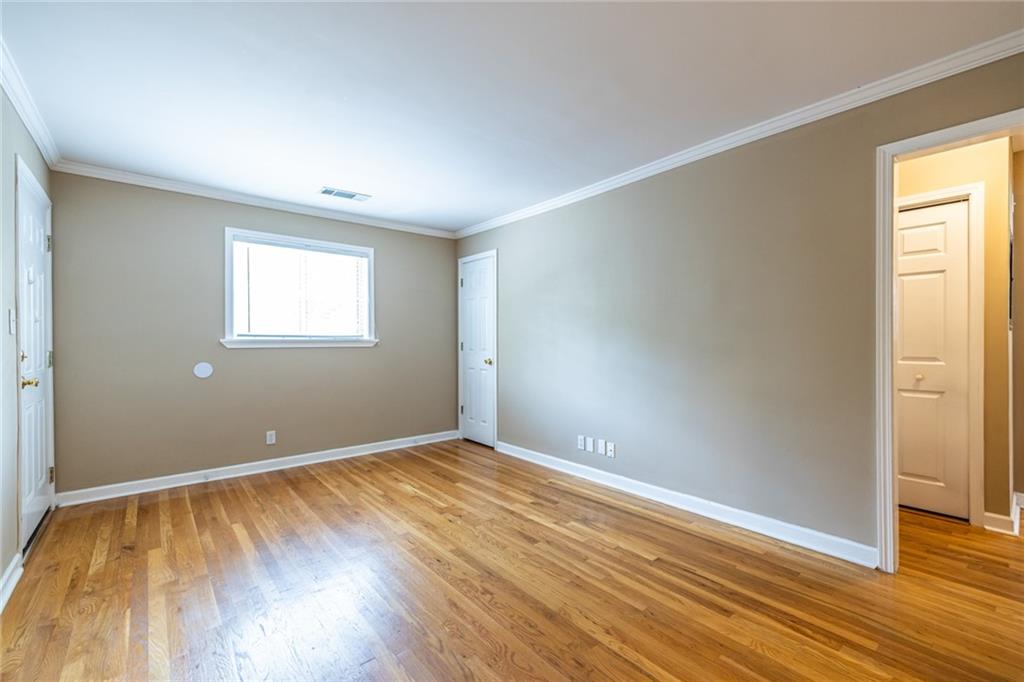 263 Jefferson Place, Unit 31 Decatur, GA 30030 - Photo 7 of 27 an empty room with wooden floor and windows