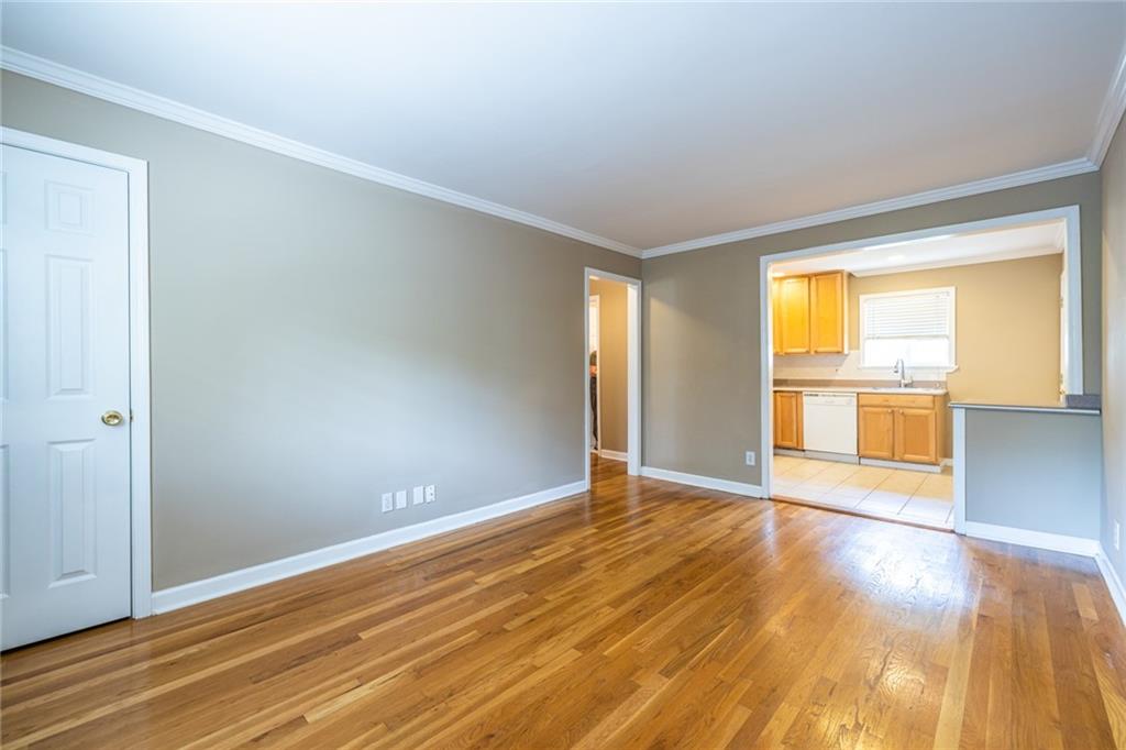 263 Jefferson Place, Unit 31 Decatur, GA 30030 - Photo 8 of 27 a view of an empty room with wooden floor and a window