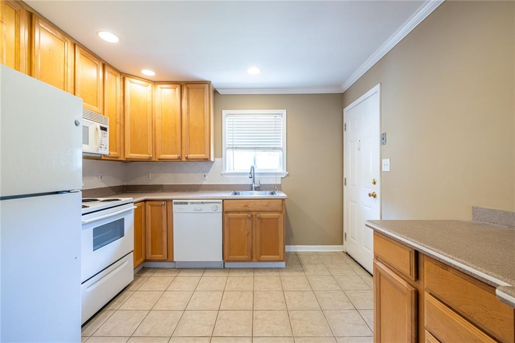 263 Jefferson Place, Unit 31 Decatur, GA 30030 - Photo 10 of 27 a kitchen with a sink a stove top oven and cabinets