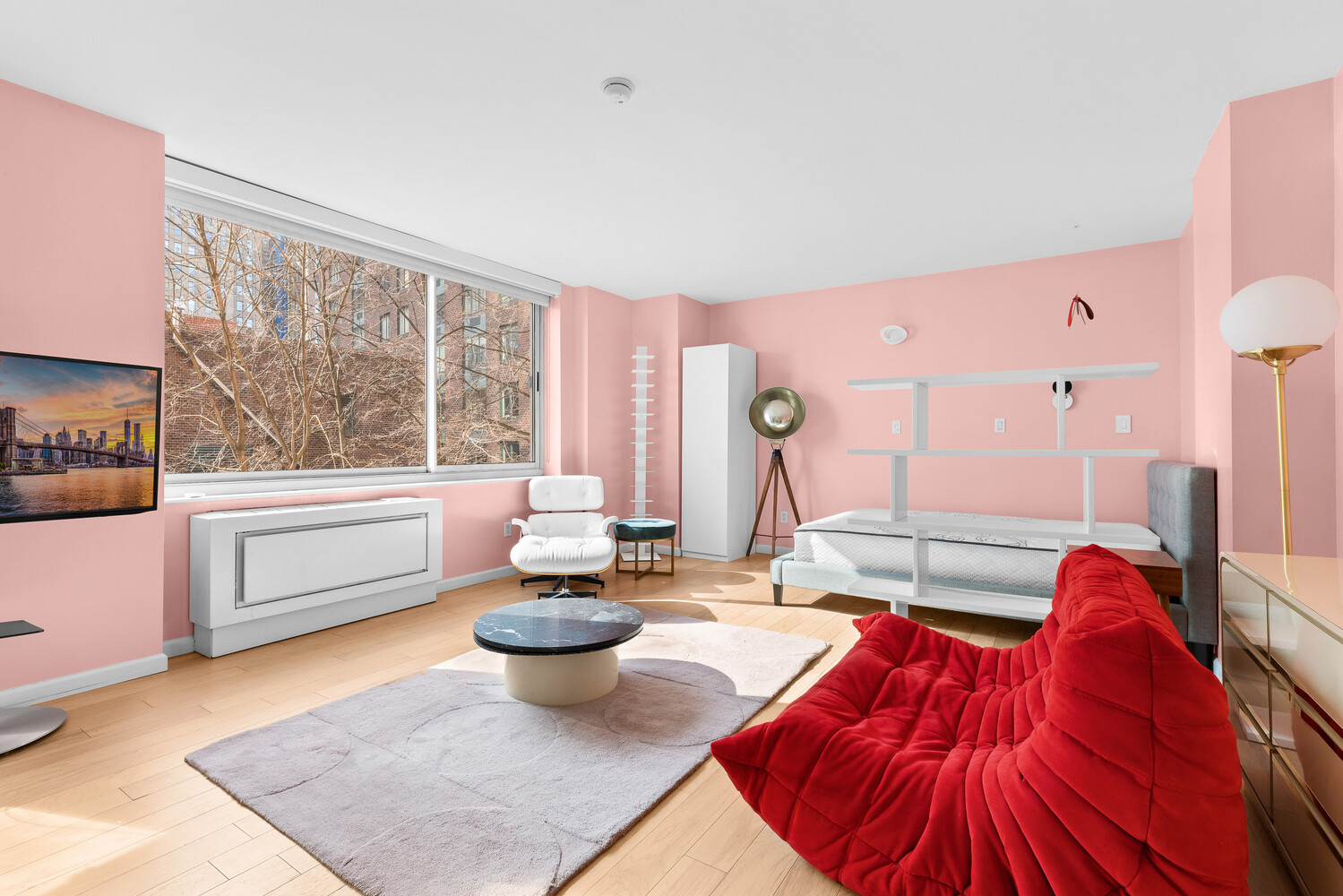 a living room with patio furniture and a large window
