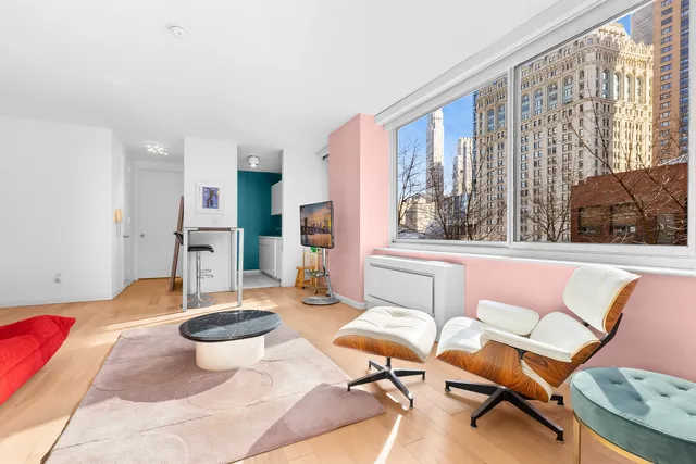 a living room with patio furniture and a large window