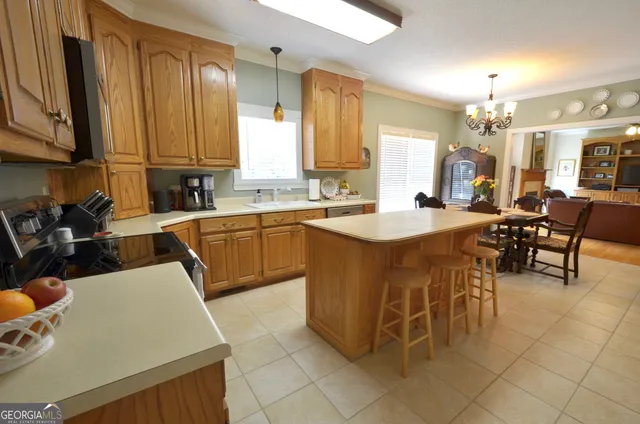a kitchen with a sink chairs and cabinets