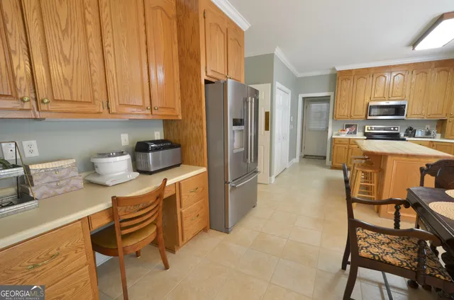 a kitchen with stainless steel appliances granite countertop a refrigerator and a stove top oven
