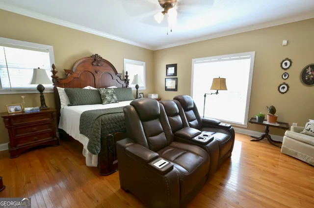a bedroom with bed couch and window