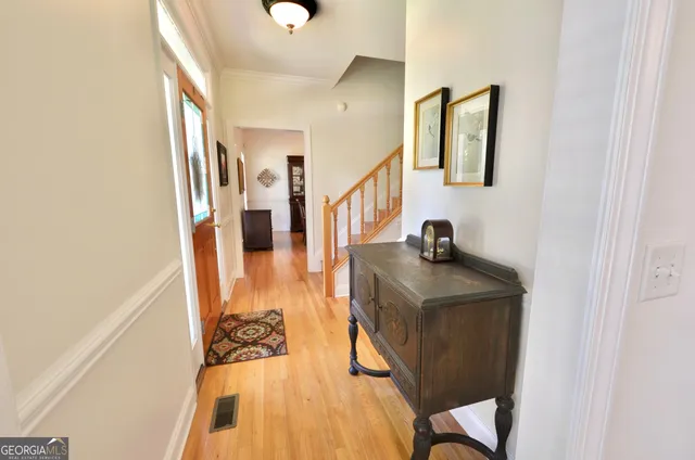 a dining room with wooden floor and a potted plant