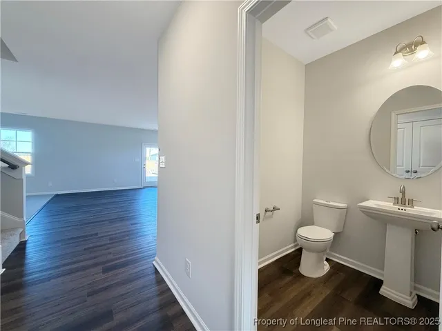 a bathroom with a sink toilet and a mirror