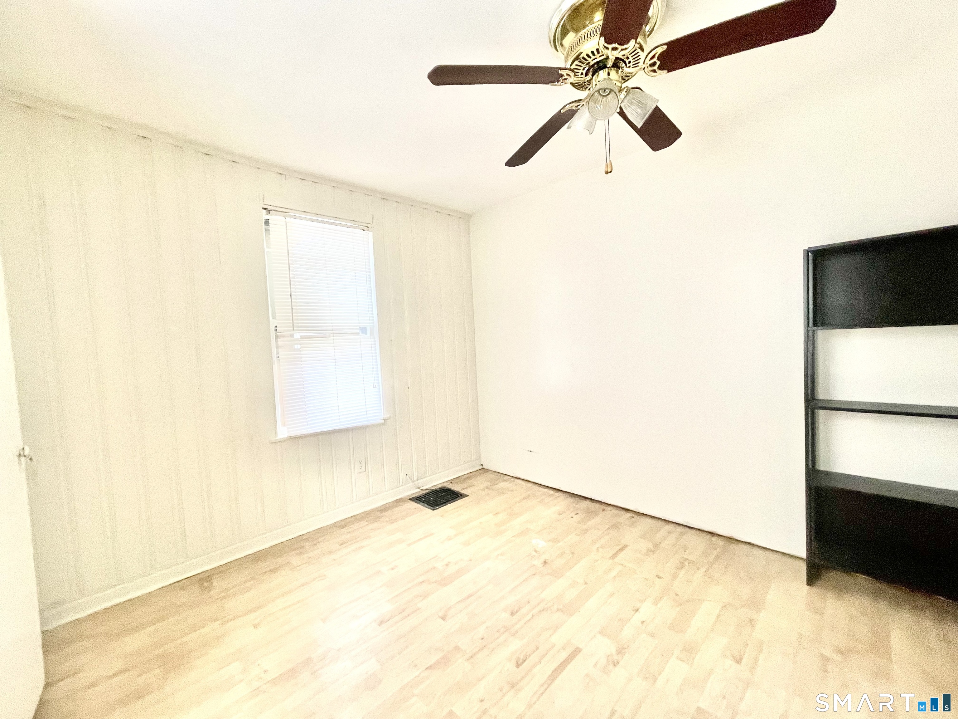 128 Franklin Street Waterbury, CT 06706 - Photo 12 of 25 a view of a big room with a ceiling fan and a window