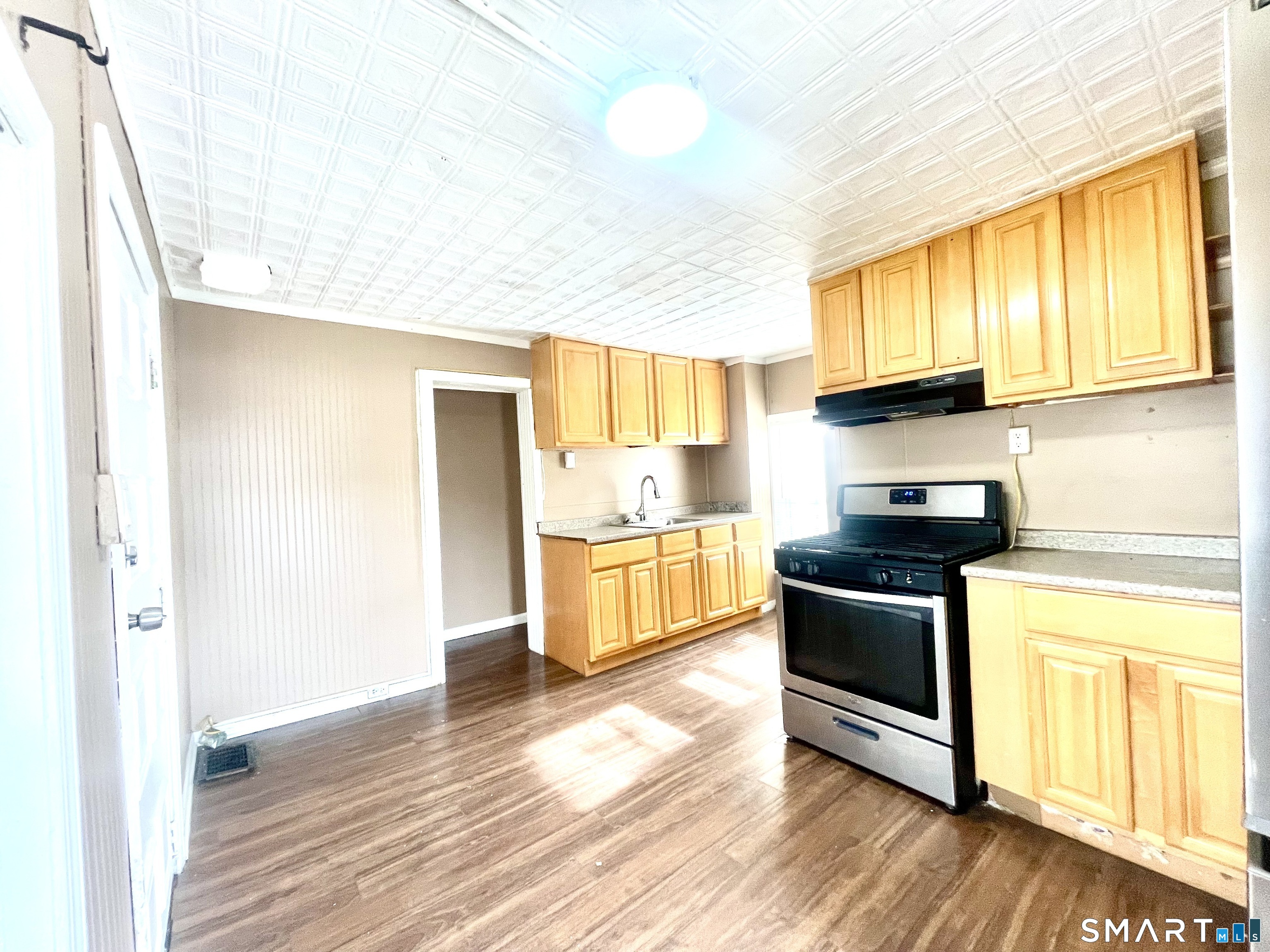 128 Franklin Street Waterbury, CT 06706 - Photo 15 of 25 a kitchen with stainless steel appliances granite countertop a stove a sink and a refrigerator