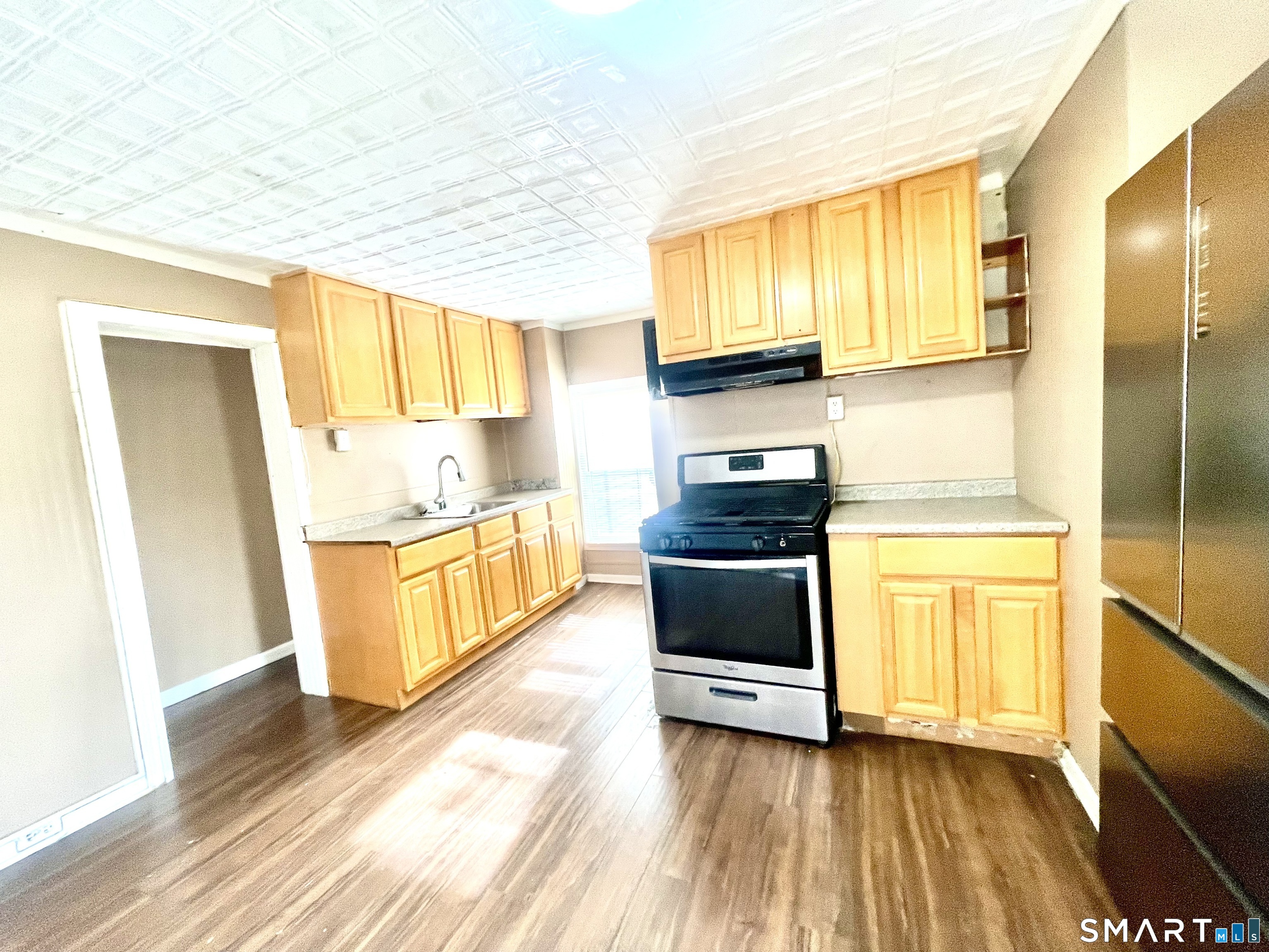 128 Franklin Street Waterbury, CT 06706 - Photo 16 of 25 a kitchen with stainless steel appliances a stove a sink and a refrigerator