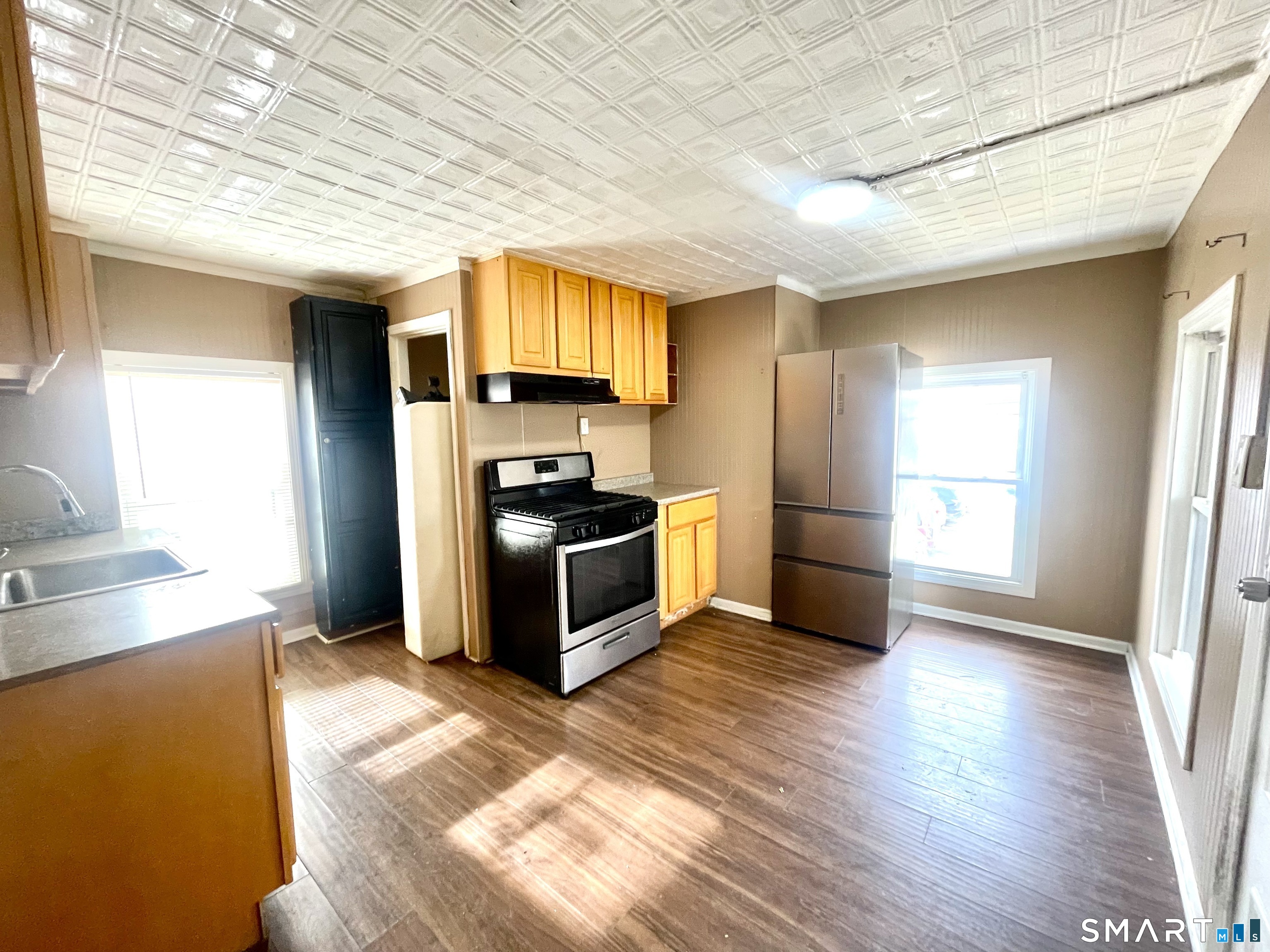 128 Franklin Street Waterbury, CT 06706 - Photo 17 of 25 a kitchen with stainless steel appliances a refrigerator and a sink
