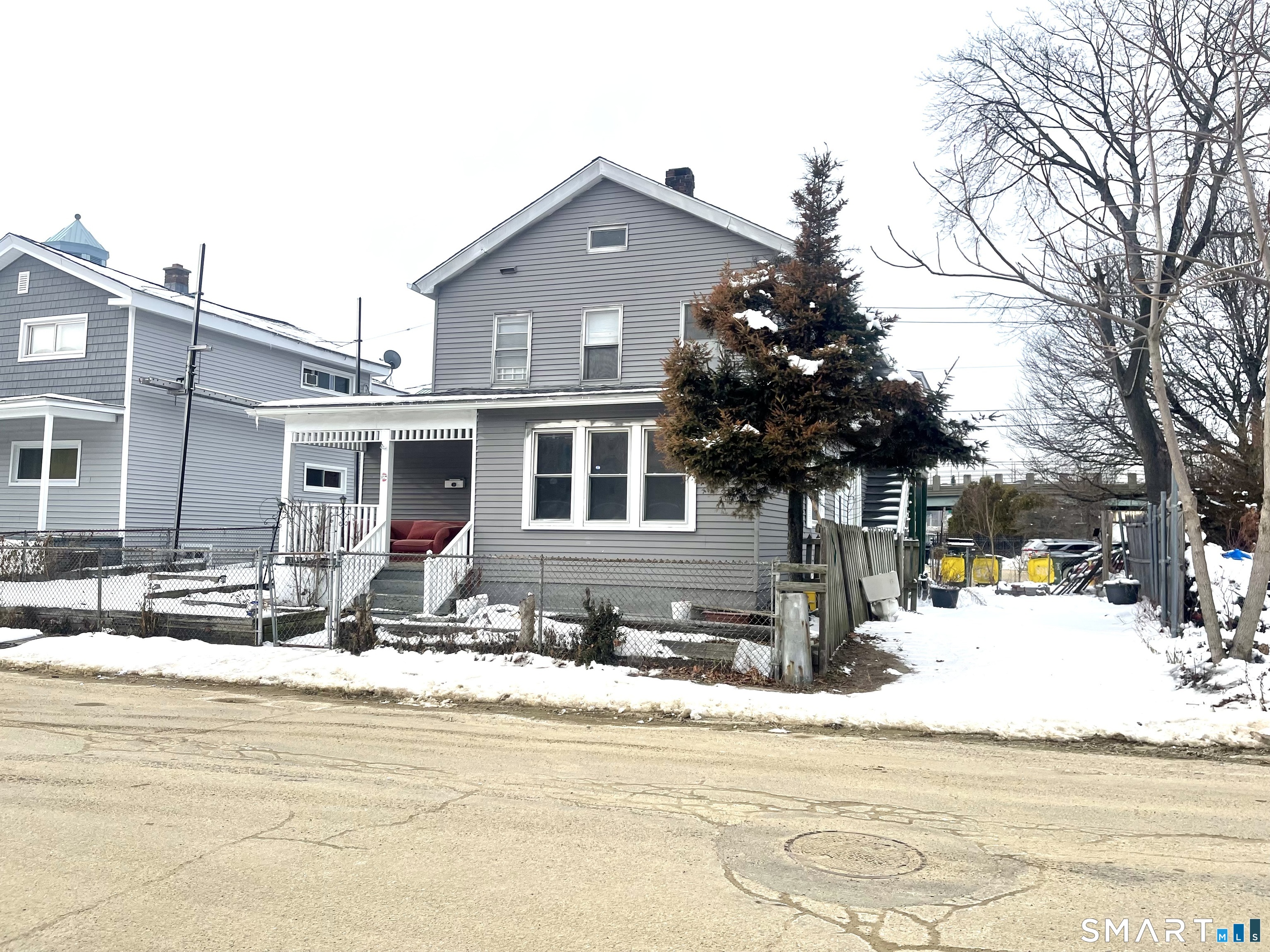 128 Franklin Street Waterbury, CT 06706 - Photo 2 of 25 a front view of a house with a yard