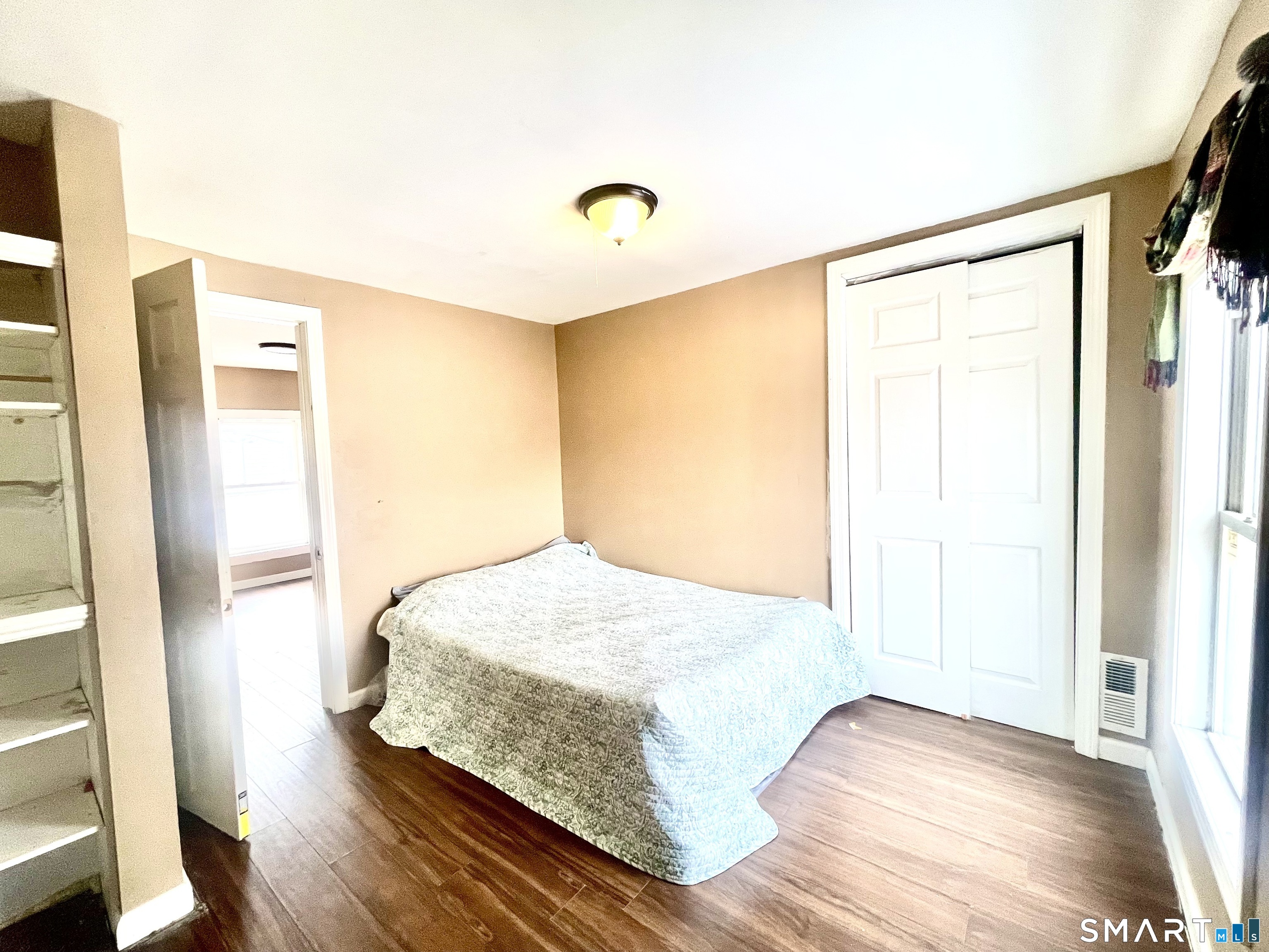 128 Franklin Street Waterbury, CT 06706 - Photo 25 of 25 a bedroom with a bed and wooden floor