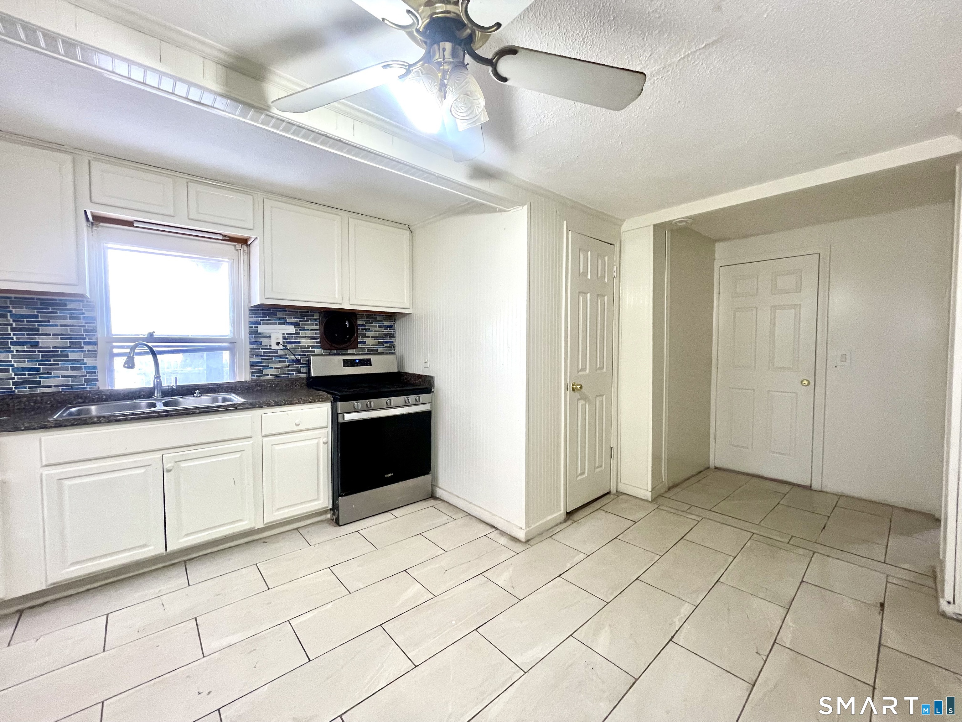 128 Franklin Street Waterbury, CT 06706 - Photo 6 of 25 a kitchen with stainless steel appliances granite countertop a refrigerator and a sink