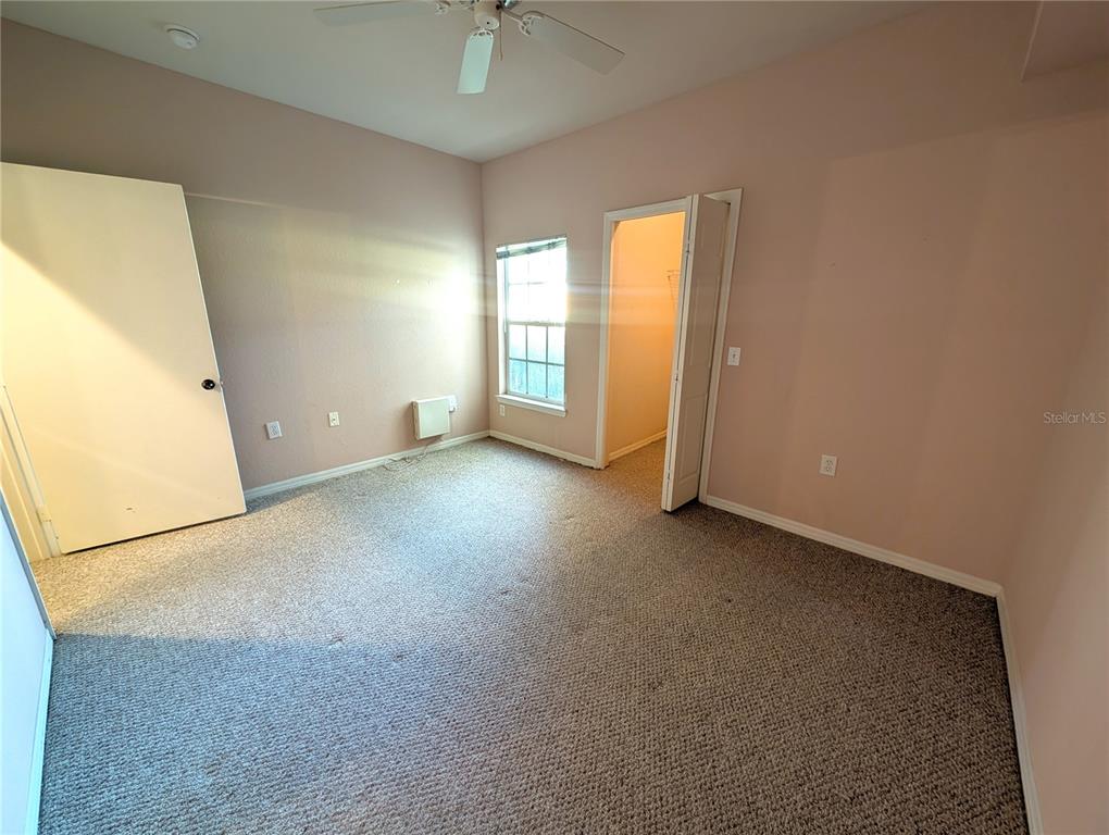 5122 Northridge Road, Unit 110 Sarasota, FL 34238 - Photo 14 of 23 an empty room with windows and entrance