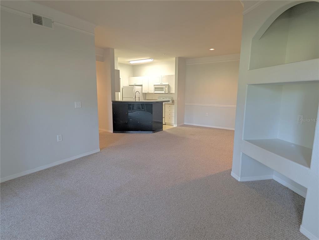 5122 Northridge Road, Unit 110 Sarasota, FL 34238 - Photo 4 of 23 a view of a big room with wooden floor and windows