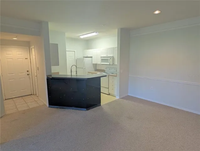 an empty room with a sink and mirror