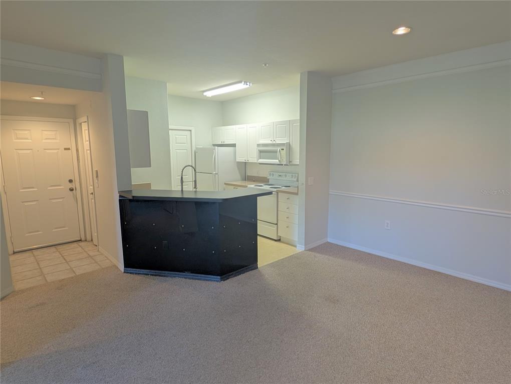 5122 Northridge Road, Unit 110 Sarasota, FL 34238 - Photo 5 of 23 an empty room with a sink and mirror