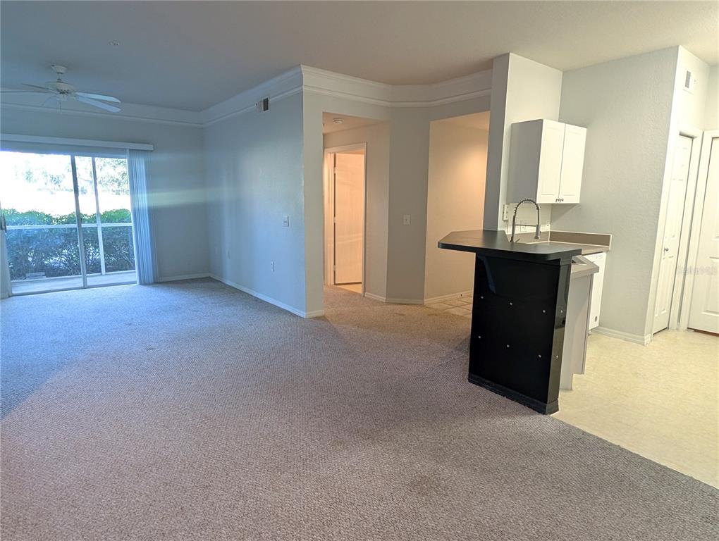 5122 Northridge Road, Unit 110 Sarasota, FL 34238 - Photo 6 of 23 a view of an empty room with a fireplace and a window
