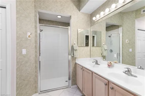 a bathroom with a shower sink and mirror