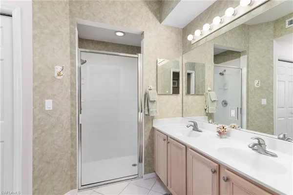 a bathroom with a shower sink and mirror