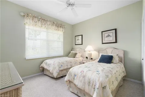 a bedroom with two beds and a window