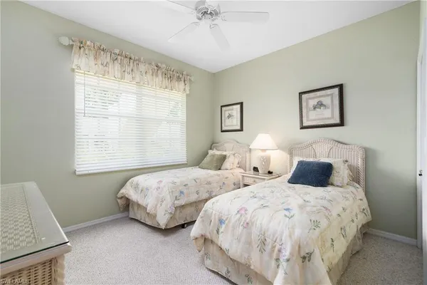 a bedroom with two beds and a window