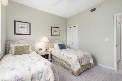 a bedroom with two beds and painting on the wall