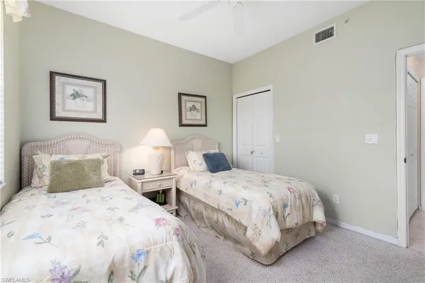 a bedroom with two beds and painting on the wall