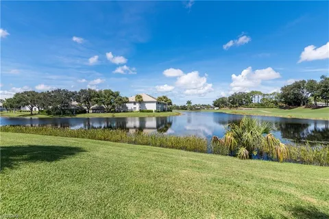 a view of a lake with houses in the back