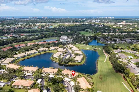 an aerial view of water body with boats and trees all around