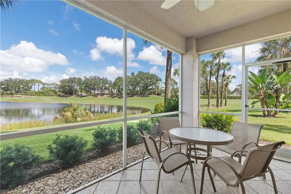a view of a patio with furniture and a lake view