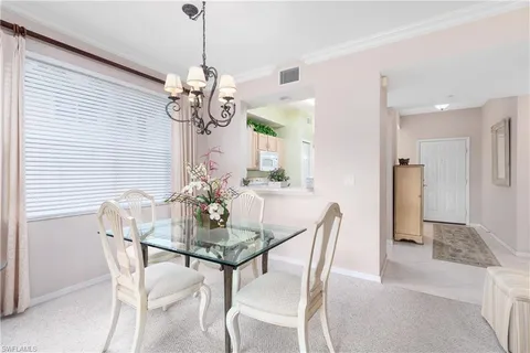 a dining room with furniture and chandelier