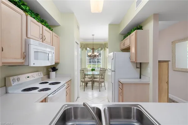 a kitchen with a sink a stove and cabinets