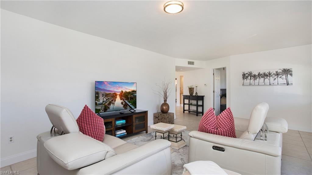 1560 Blue Point Avenue, Unit 3 Naples, FL 34102 - Photo 11 of 43 a living room with furniture and a rug