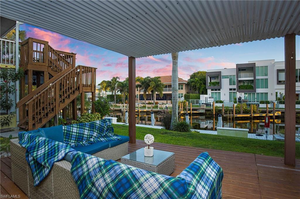 1560 Blue Point Avenue, Unit 3 Naples, FL 34102 - Photo 3 of 43 a view of a patio with couches table and chairs and potted plants