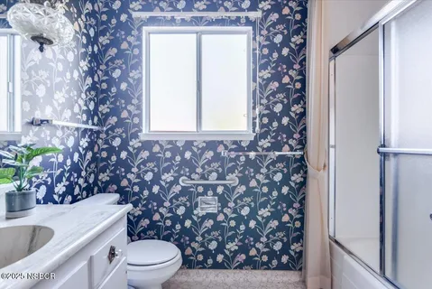 a spacious bedroom with a bed and a large window