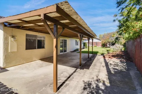 a view of an house with backyard and furniture